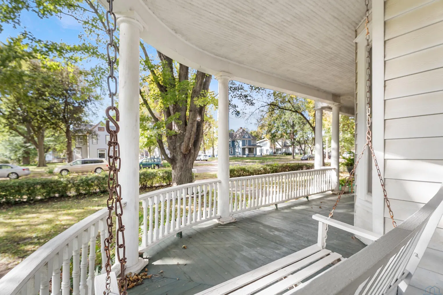 Historic bedroom with large windows and hardwood flooring