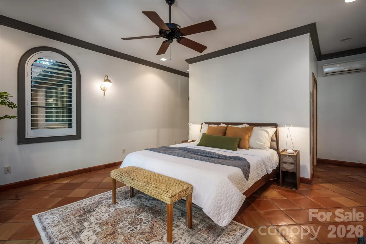 Spacious primary suite with private Juliet balcony overlooking the gardens