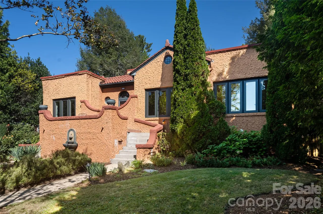 The Kenilworth Casa front exterior with circular driveway and lush landscaping in Asheville NC